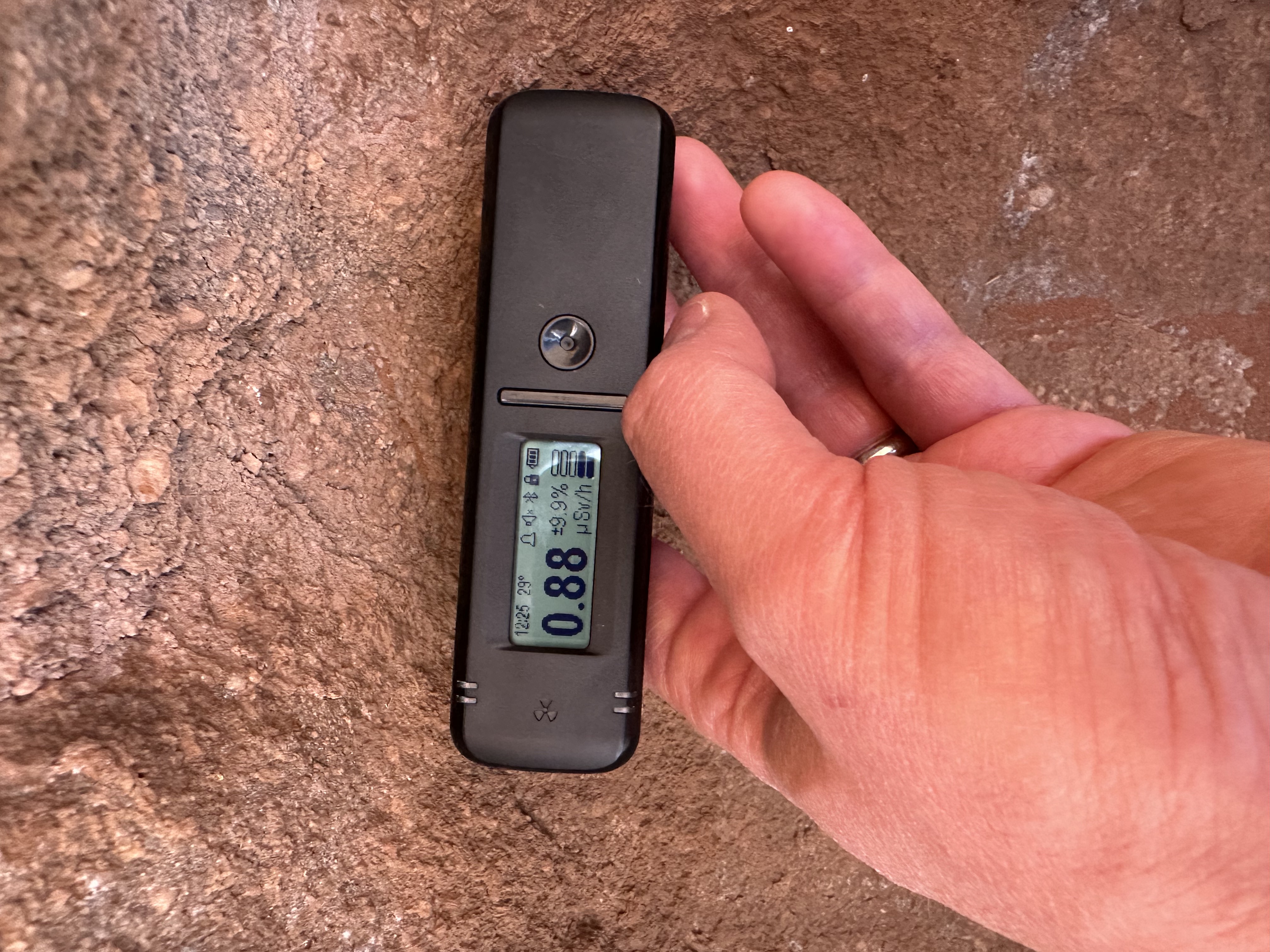 Radiacode 101 showing the dose next to Uluru / Ayer's Rock